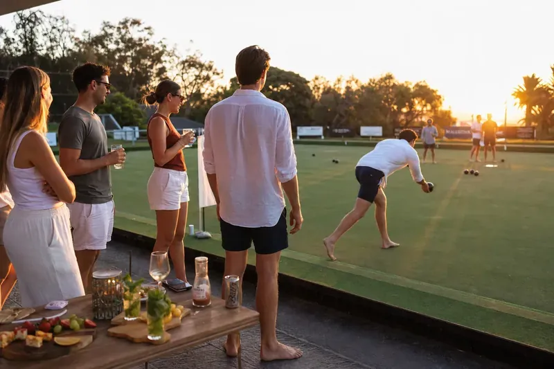 Barefoot bowls social event at sunset